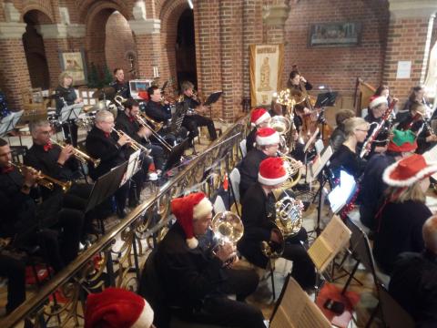 Band wearing Christmas hats for finale